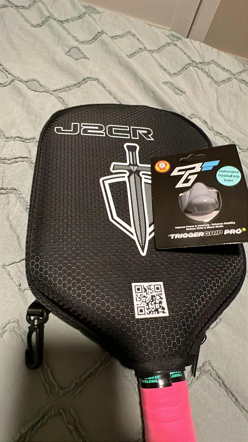 TriggerGrip Pro pickleball grip insert packaging shown with black pickleball paddle and installed grip