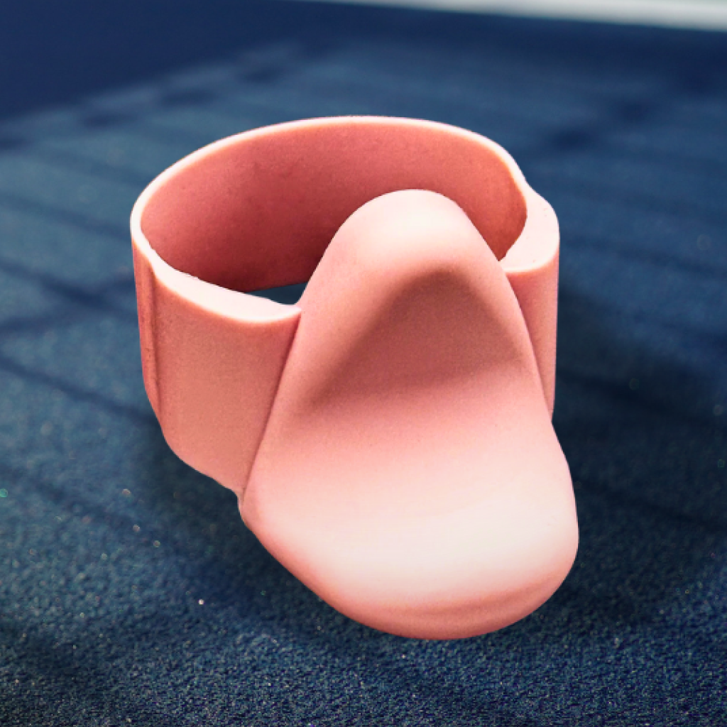 Coral Pink TriggerGrip Pro pickleball paddle grip insert close-up on court surface