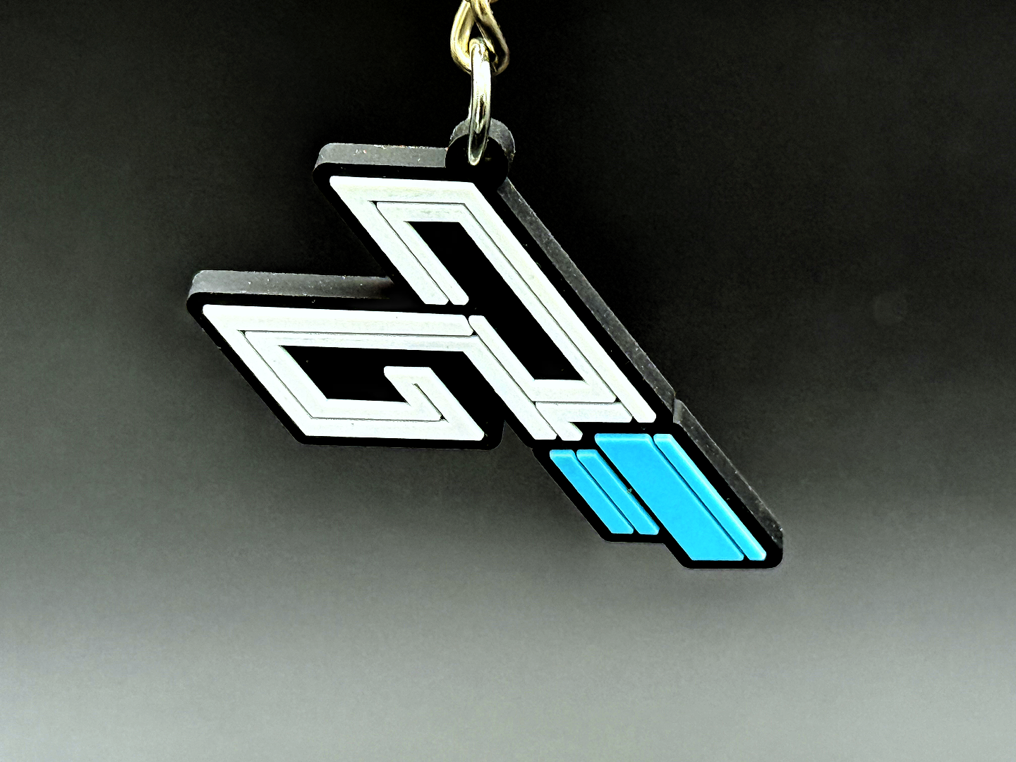 TriggerGrip Pro logo keychain accessory in black, white, and blue, designed for pickleball fans and players